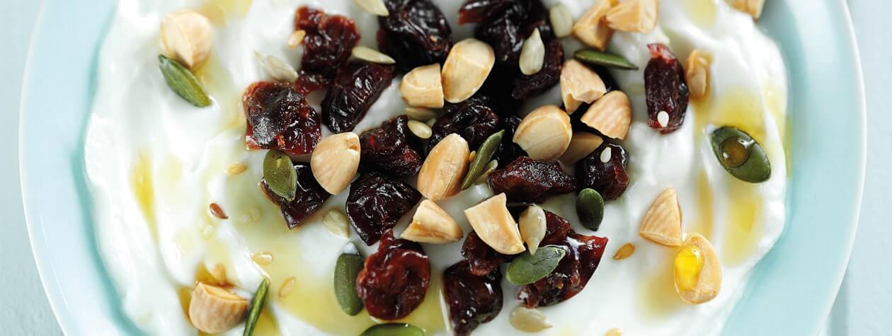 Yoghurt topped with Dried Cherries, Almonds & Seeds & drizzled with Maple Syrup